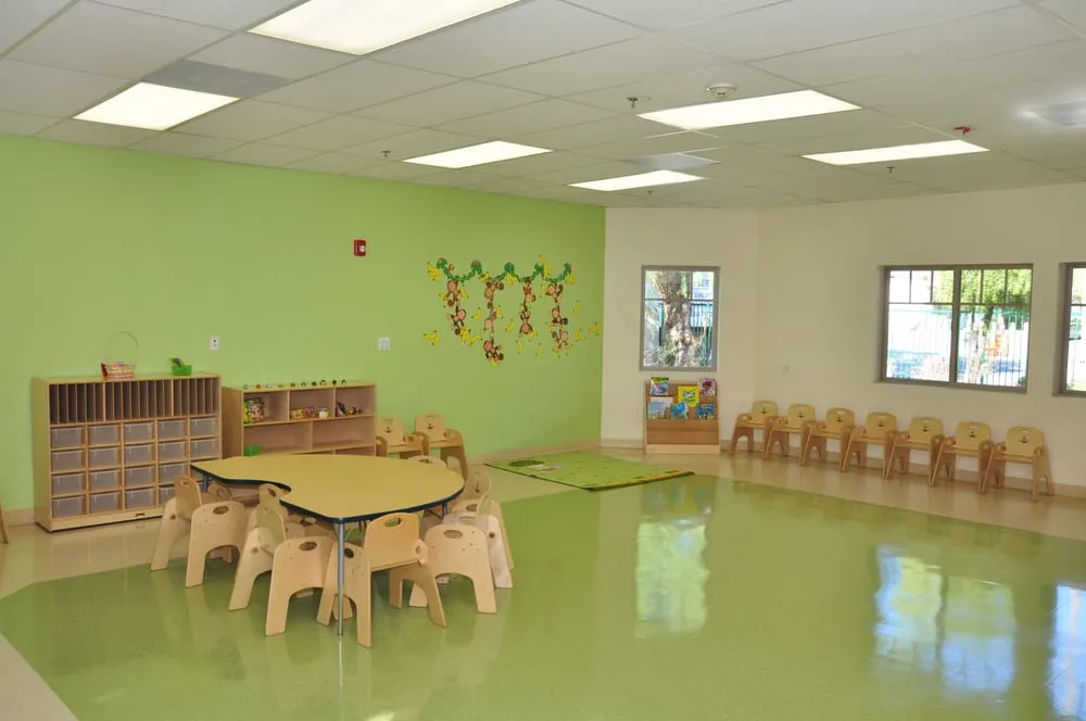 Green classroom at Kids Planet Sun Valley with shelves, tables, and windows