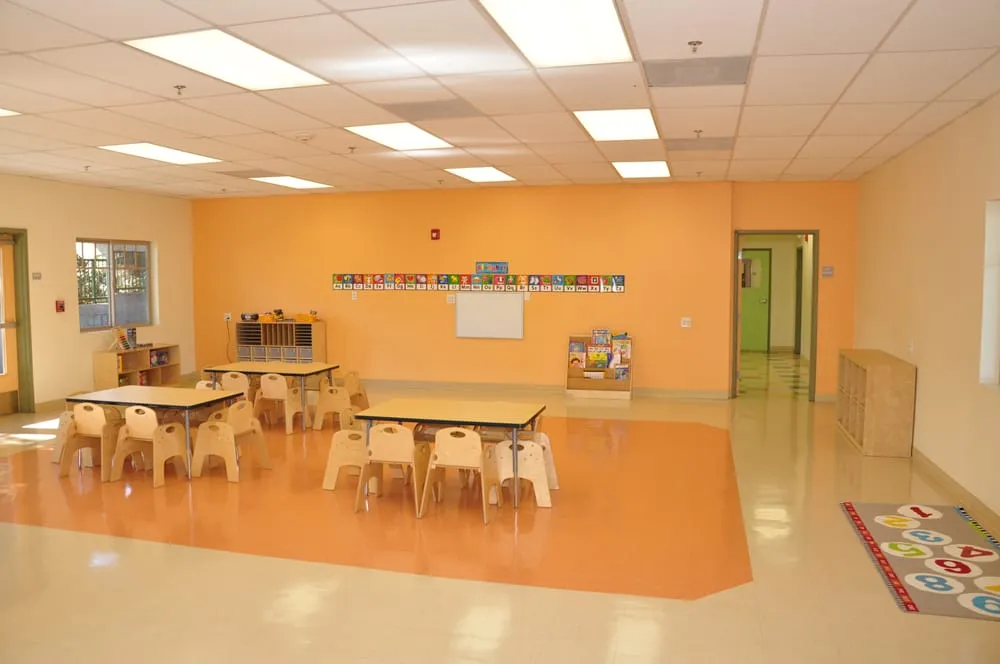 Orange classroom at Kids Planet Sun Valley with learning tables and classroom materials